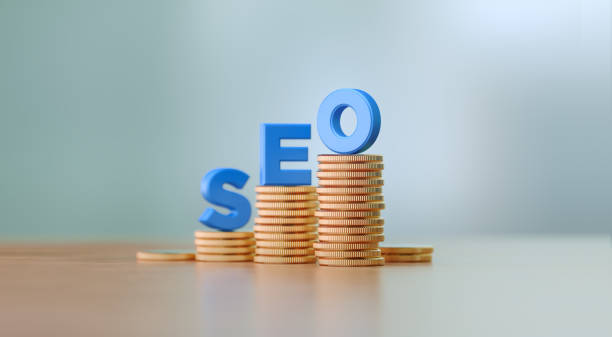 istock Blue Letters Sitting On Coin Stacks Writes SEO Before Defocused Background 1291280324