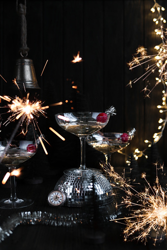 New Year's Eve Champagne Cocktails with golden Sparklers for midnight celebration