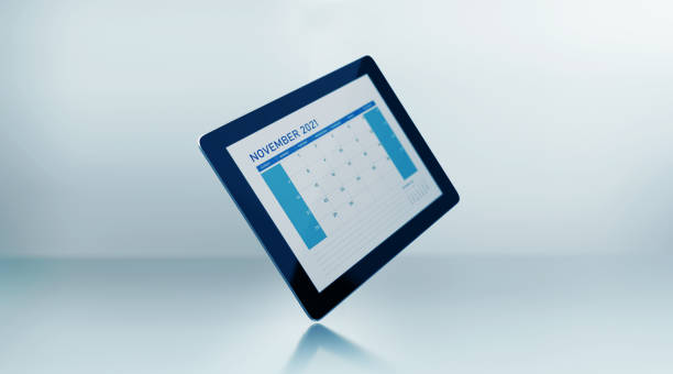 2021 monthly digital calendar: November. Horizontal composition with copy space. The calendar is blue in color and sitting before a reflective defocused background. Reminder concept.