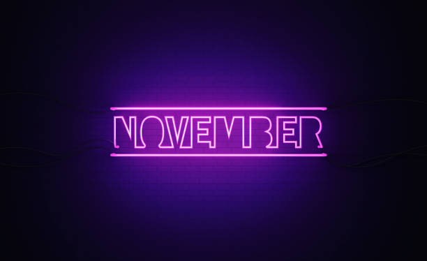 istock Purple Neon Light Writes November on Black Bricked Wall 1291282286