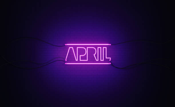 istock Purple Neon Light Writes April on Black Bricked Wall 1291282322