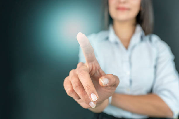 Close up of business woman touching digital screen with finger stock photo