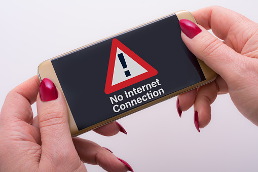 No internet connection warning sign on screen of  her smartphone