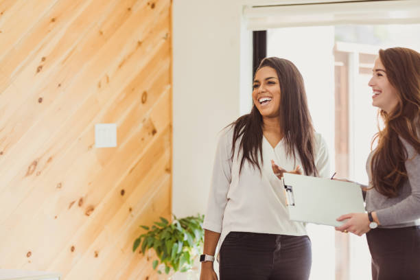 istock Female colleagues laugh together 1291284606