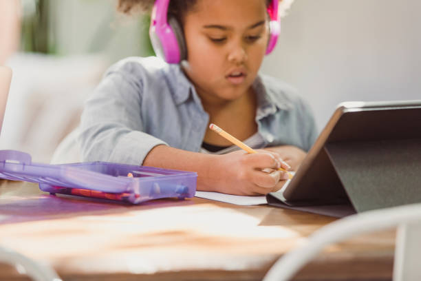 istock Homeschooling girl uses digital tablet to do schoolwork 1291284646