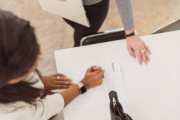 istock New home buyer signing paperwork 1291284700