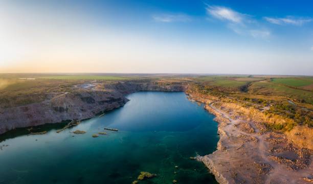 istock Old flooded stone quarry, site of natural granite stone mining 1291285946