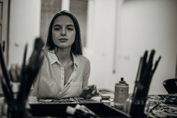 istock Beautiful woman painting in her studio 1291286850