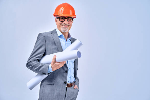 istock Positive mature architect holding paperwork blueprints rolls 1291287914