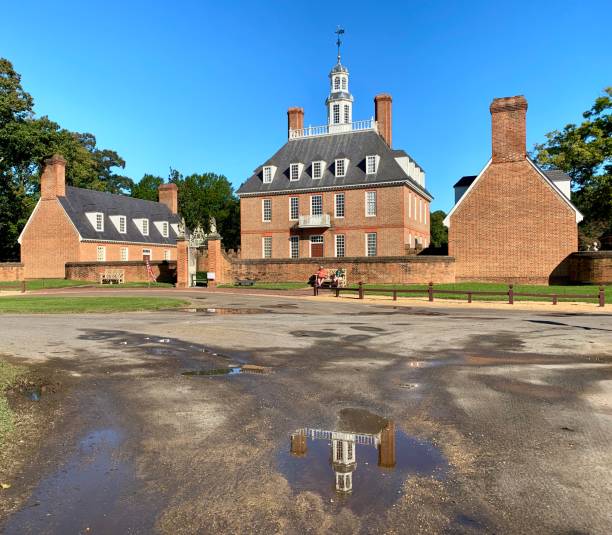 Governor's Palace Reflected in Puddle in Williamsburg, Virginia. USA Williamsburg, VA, USA - September 30, 2020: A sunny day view of the Governor's Palace, the home for the Royal Governors in Williamsburg, Virginia, USA. governor's palace williamsburg stock pictures, royalty-free photos & images