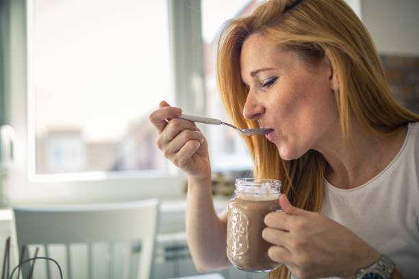 istock Woman trying out a milk shake she made 1291288115