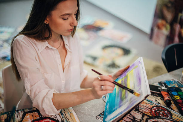 istock One young woman painter painting in her studio 1291288141