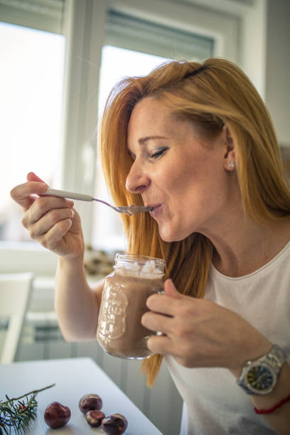 istock Woman trying out a milk shake she made 1291288169