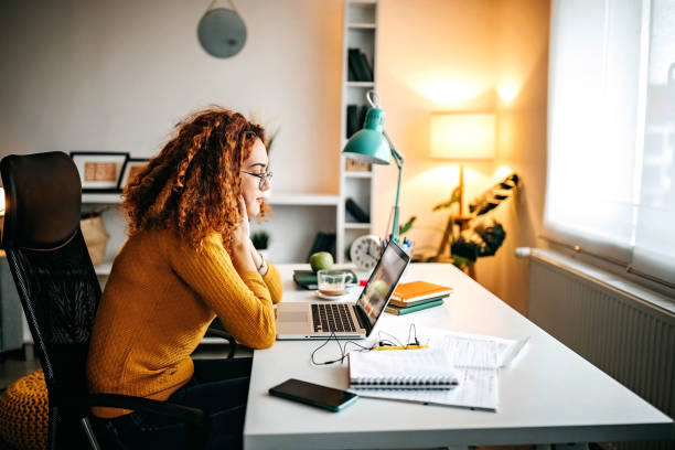 This day has no end Teenage girl using laptop and internet to study online student desk stock pictures, royalty-free photos & images