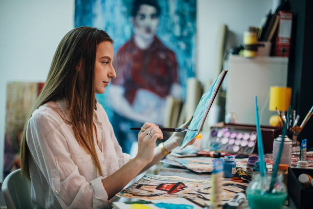 istock One young woman painting in her studio 1291289021