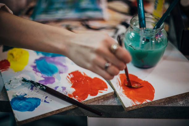 istock Close up of woman's hand mixing paints 1291289071