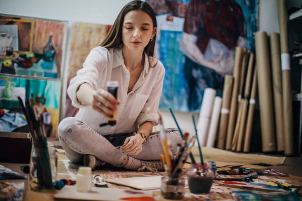 istock One woman painting and drawing in her art studio 1291289227