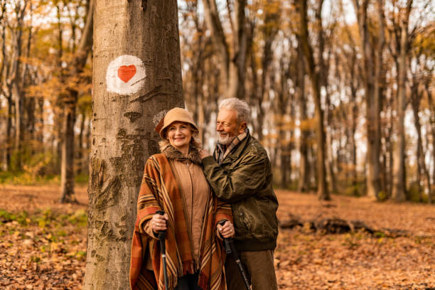 istock Happy senior couple having fun in the forest. 1291290901