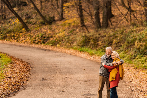 istock Senior couple walking together on a forest road. 1291290958