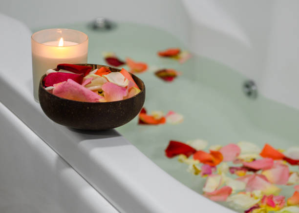 istock a relaxing candle and rose petals in a bathroom 1291290971
