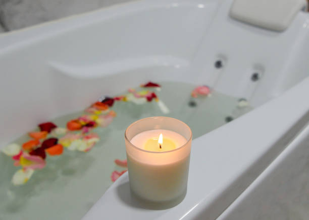 istock a relaxing candle and rose petals in a bathroom 1291290973