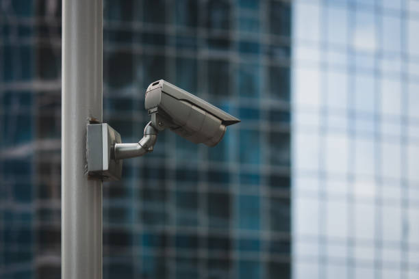 istock External security camera on pole in front of glass building wall 1291291221