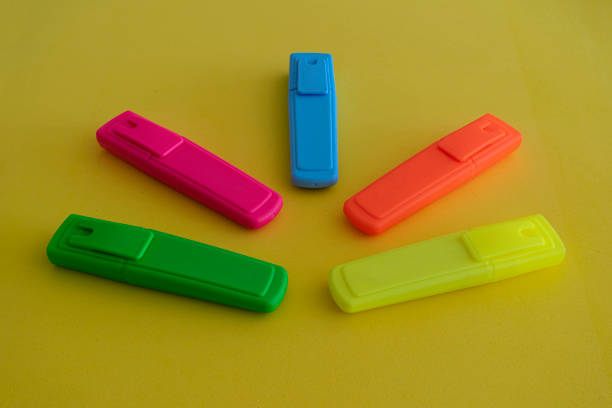 istock highlighter pencils. various colors on yellow background 1291294430