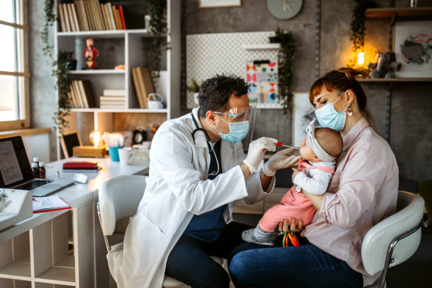 istock Pediatrician taking a mouth swab sample from a baby 1291295280