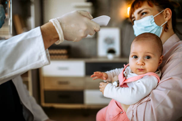 istock Doctor using no contact forehad infrared thermometer 1291295297