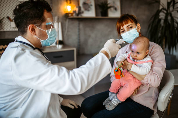 istock Doctor checking a temperature to a baby 1291295304