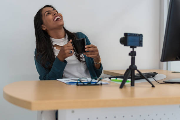 istock Young woman working in the office and drinking tea 1291298435