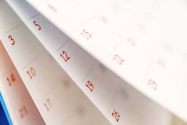 istock Calendar page flipping sheet close up on office table background business schedule planning appointment meeting concept 1291299877