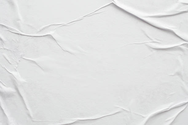 istock Blank white crumpled and creased paper poster texture background 1291299891
