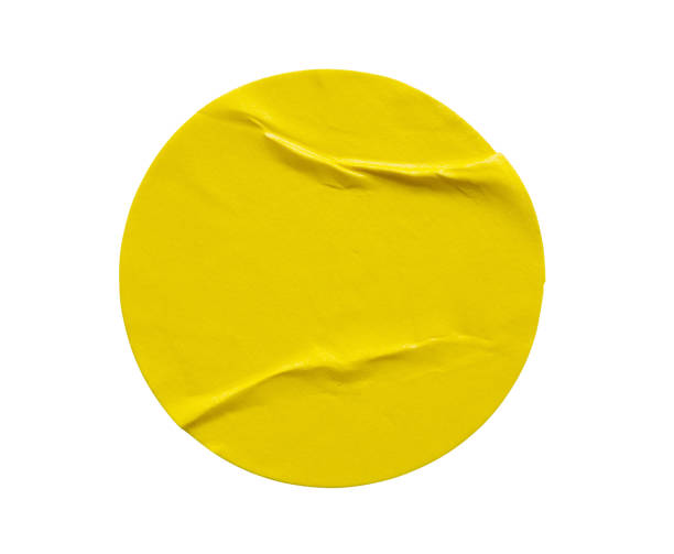 istock Yellow round paper sticker label isolated on white background 1291299921