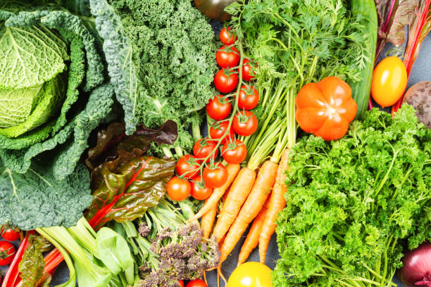 istock Variety of organic vegetables on blue table 1291300068