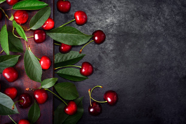istock sweet cherries with green leaves 1291303114