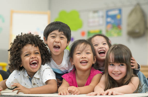 istock Multi ethnic preschool children laughing and smiling 1291308152