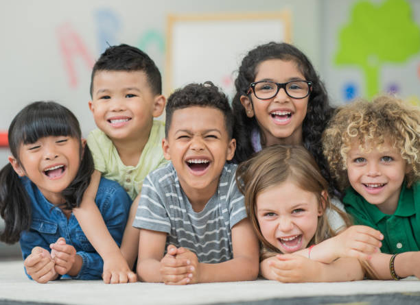 istock Multi ethnic preschool children laughing and smiling 1291308153