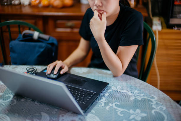 istock Young asian woman using laptop and working from home 1291309712