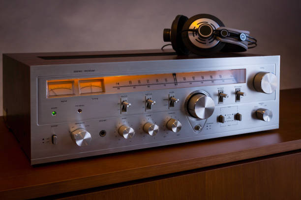 istock Vintage Audio Stereo Receiver with shiny metal front panel with headphones 1291310665