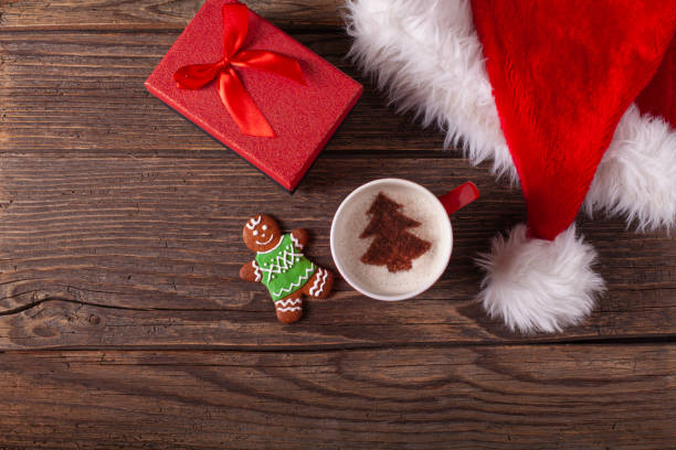 istock Christmas coffee and gingerbread cookies on rustic wooden table 1291311453