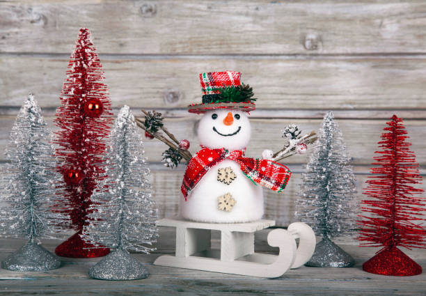 istock Christmas decorative snowman on white rustic wooden background. 1291312330