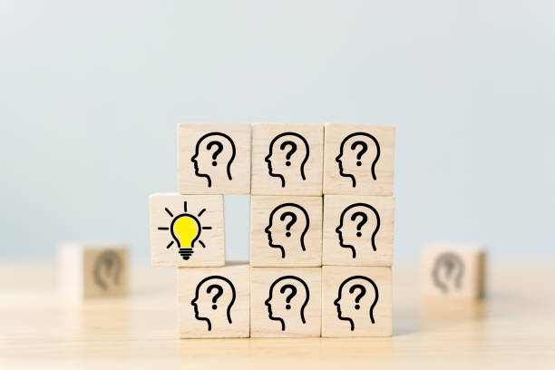 istock Concept creative idea and innovation. Wooden cube block with head human symbol and light bulb icon 1291313087