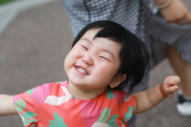istock A Chinese female kid making face with her mom as background 1291316292