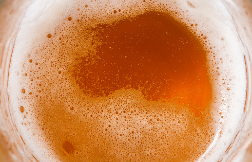 Top View Background Photo Texture of Beer Froth in a Glass or Mug