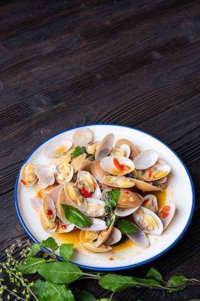 istock Stir fried Spicy Clam (Surf clam, Short necked clam, Carpet clam, Venus shell, Baby clam) with Thai Holy Basil 1291322493