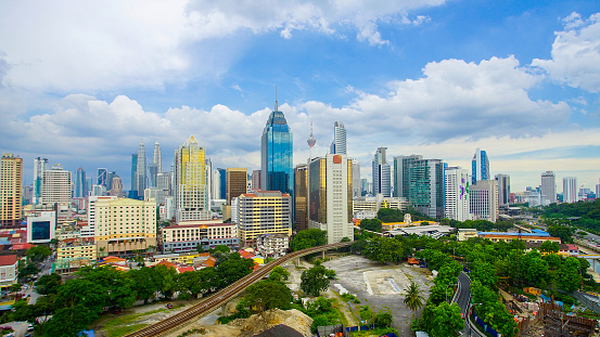 Kuala Lumpur city skyline during summer with dramatic blur sky at background