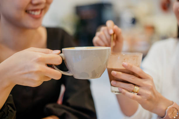 istock Two young asian women having coffee in a cafe 1291325522