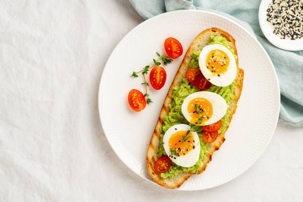 istock Avocado toast with toasted bread soft-boiled eggs with tomatoes 1291325612