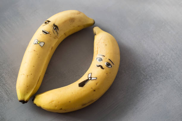 istock Banana character with funny face on gary background. 1291327355